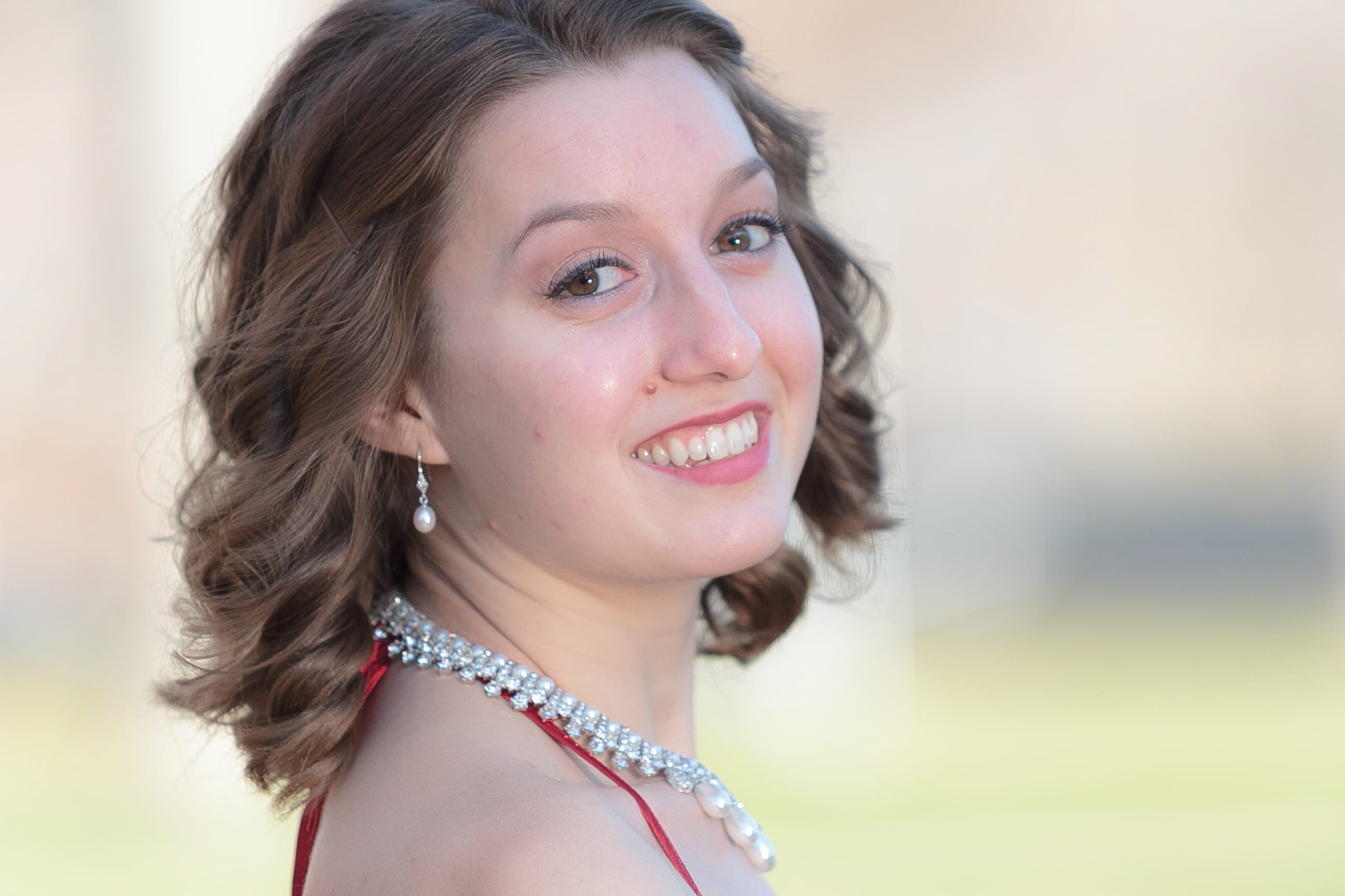Woman smiling wearing red sequined dress