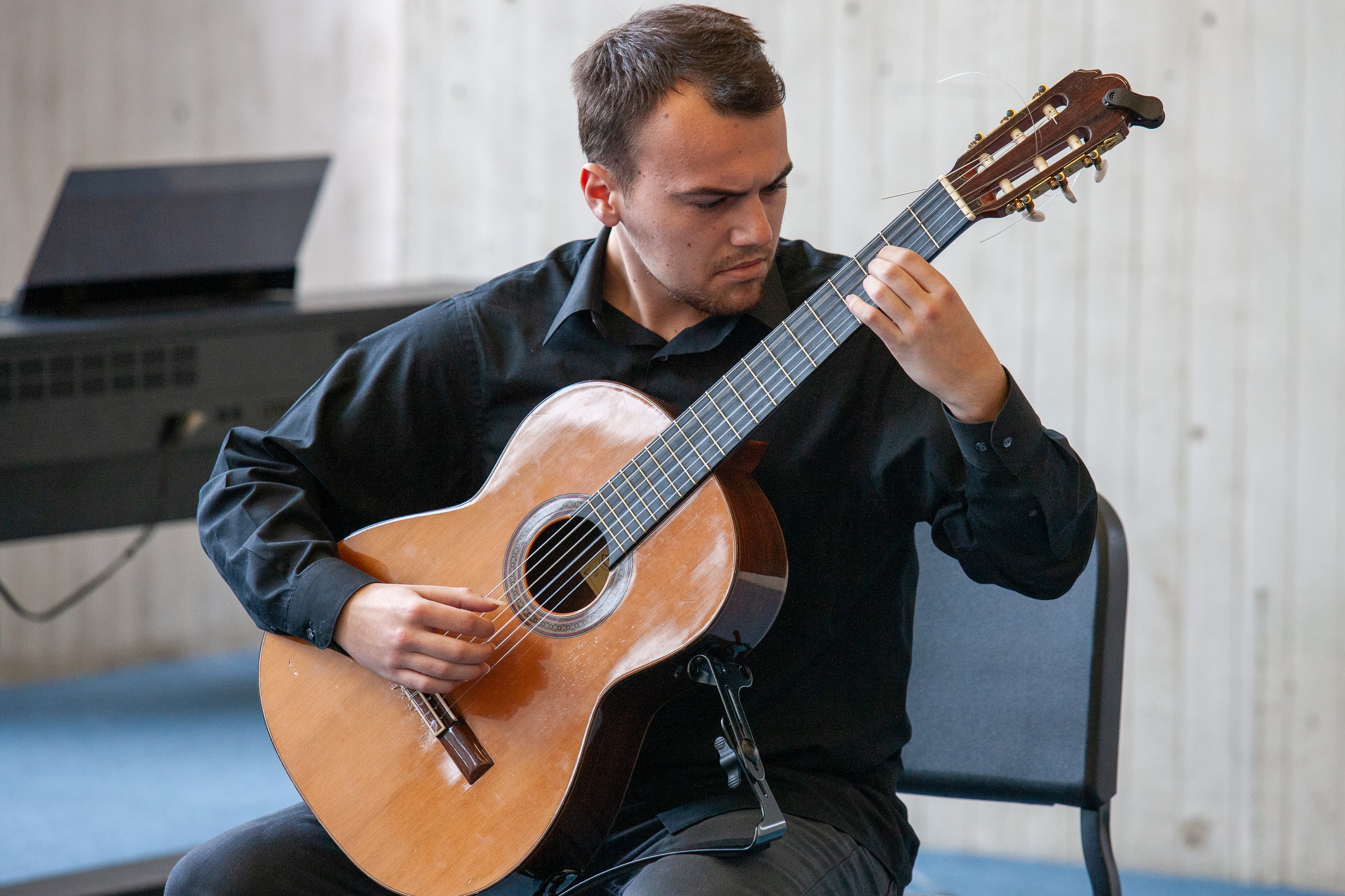 Man playing classical guitar, seated