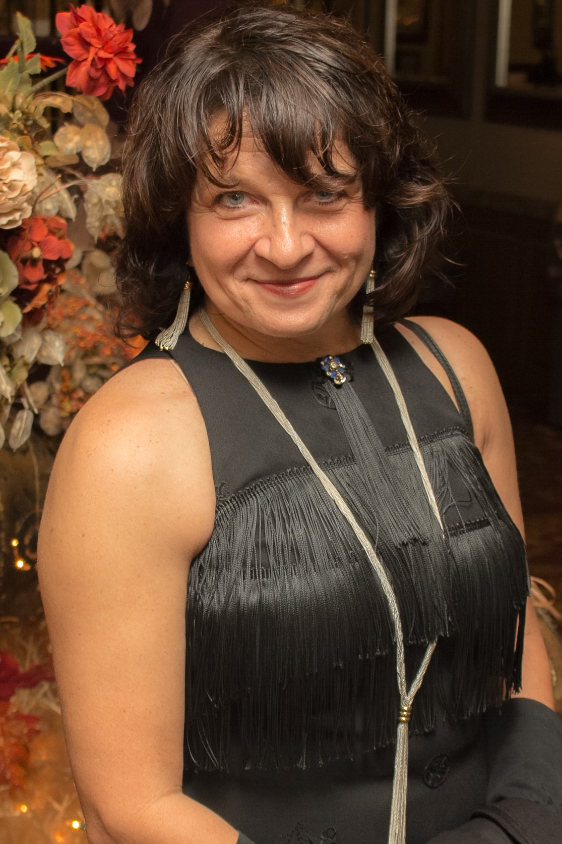 Woman in black fringe dress at formal event